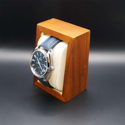 A beige wooden watch case with a microsuede interior. This stylish and functional case is made of high-quality materials and is available in both beige and grey.